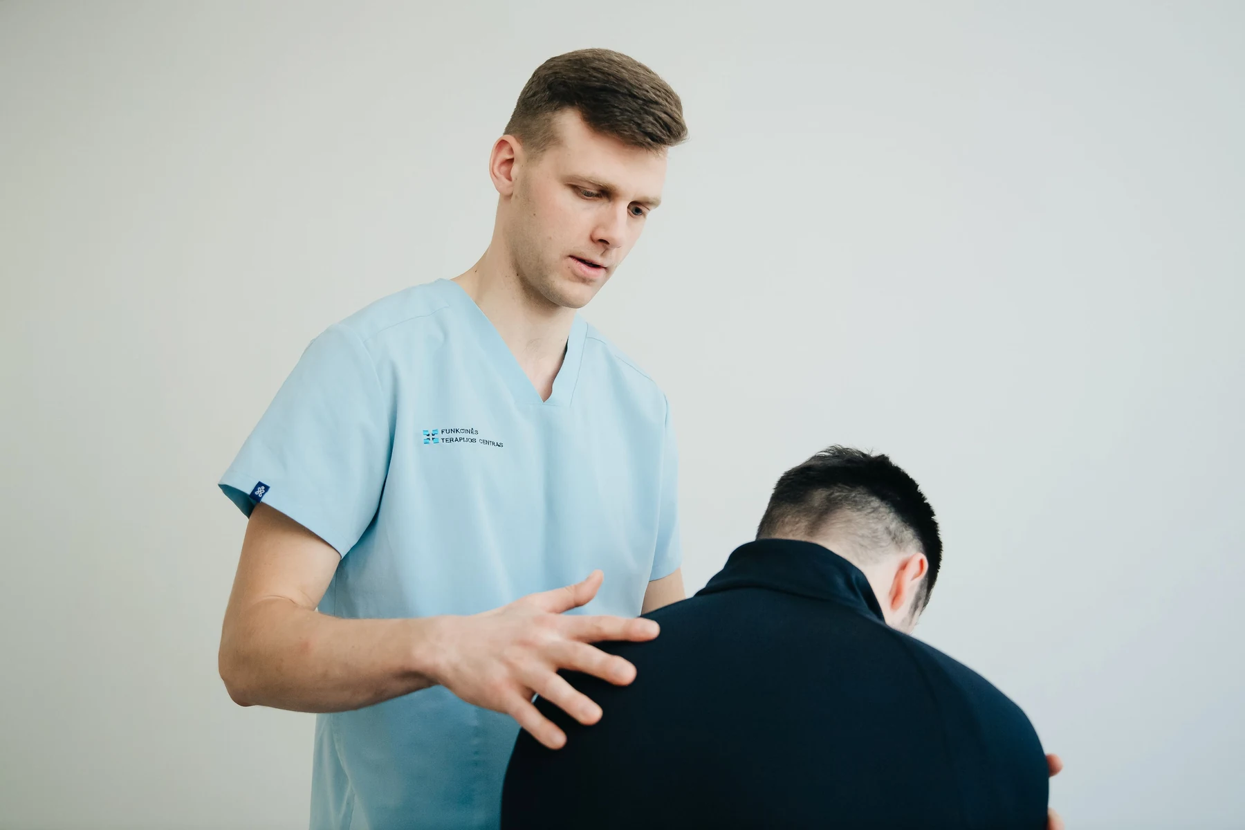 Physiotherapist assessing a patient during an initial physiotherapy appointment