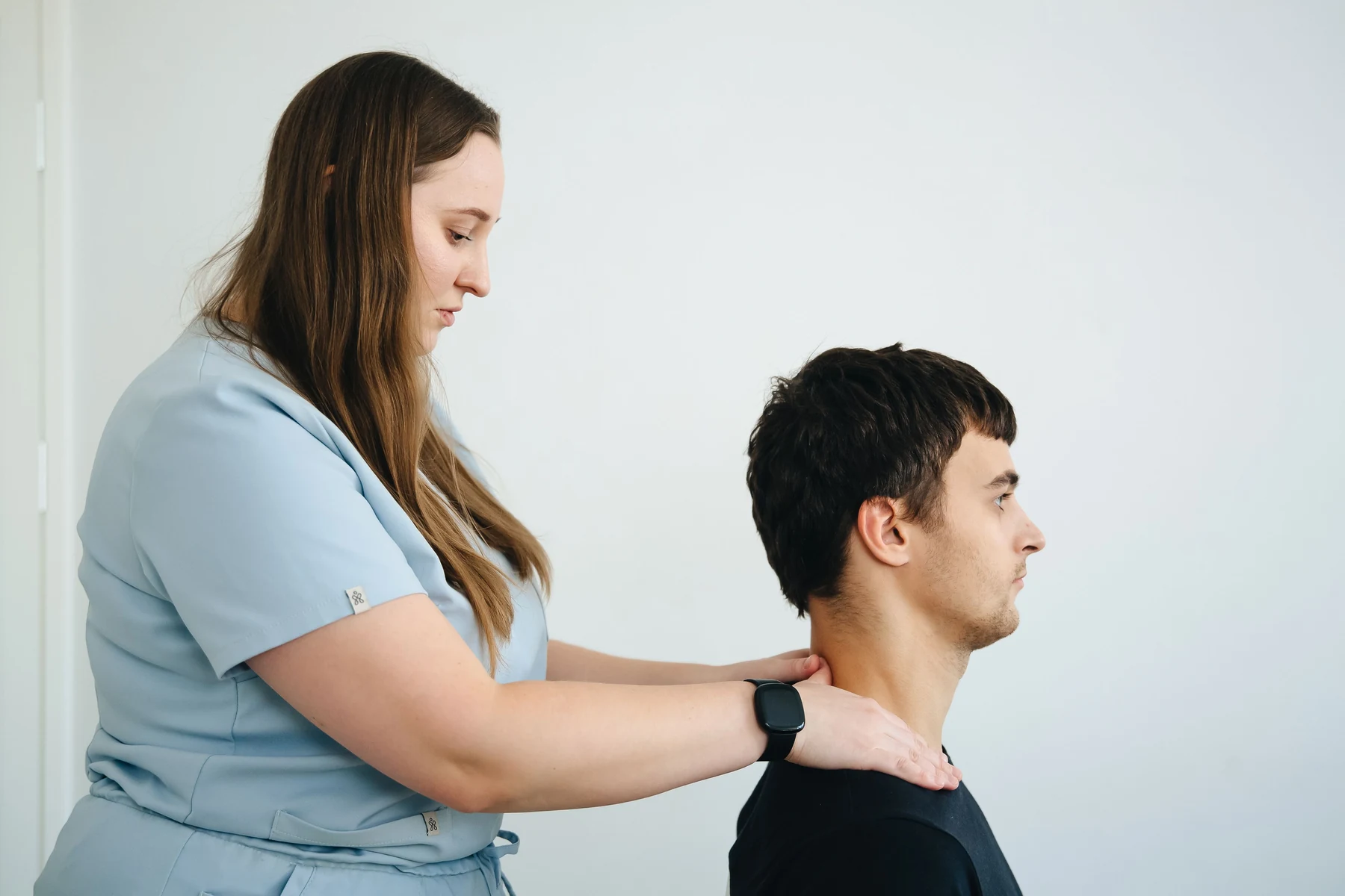 Physiotherapist treating a patient experiencing neck pain